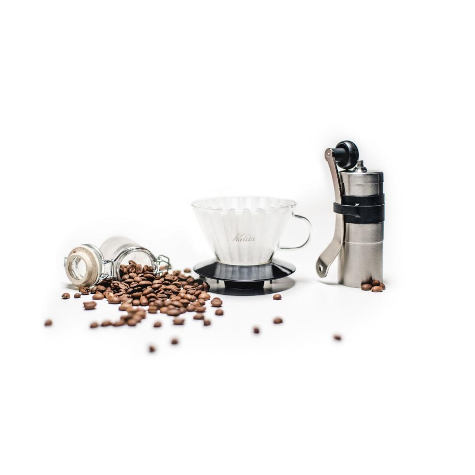 Free Image of Coffee beans with a grinder and a pour-over setup. 