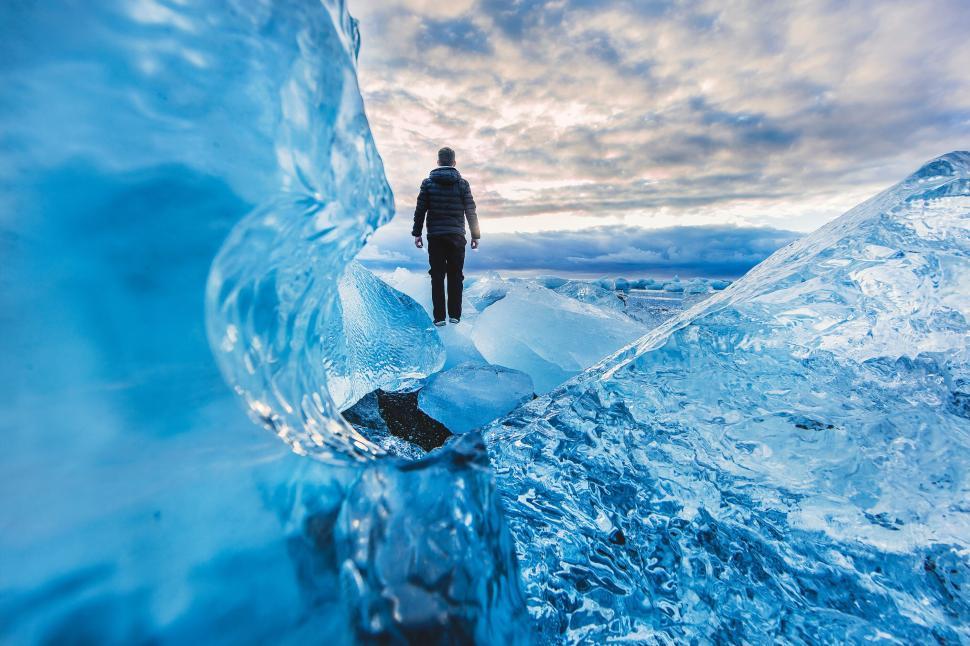 Free Image of Person on ice landscape with blue sky and clouds. 
