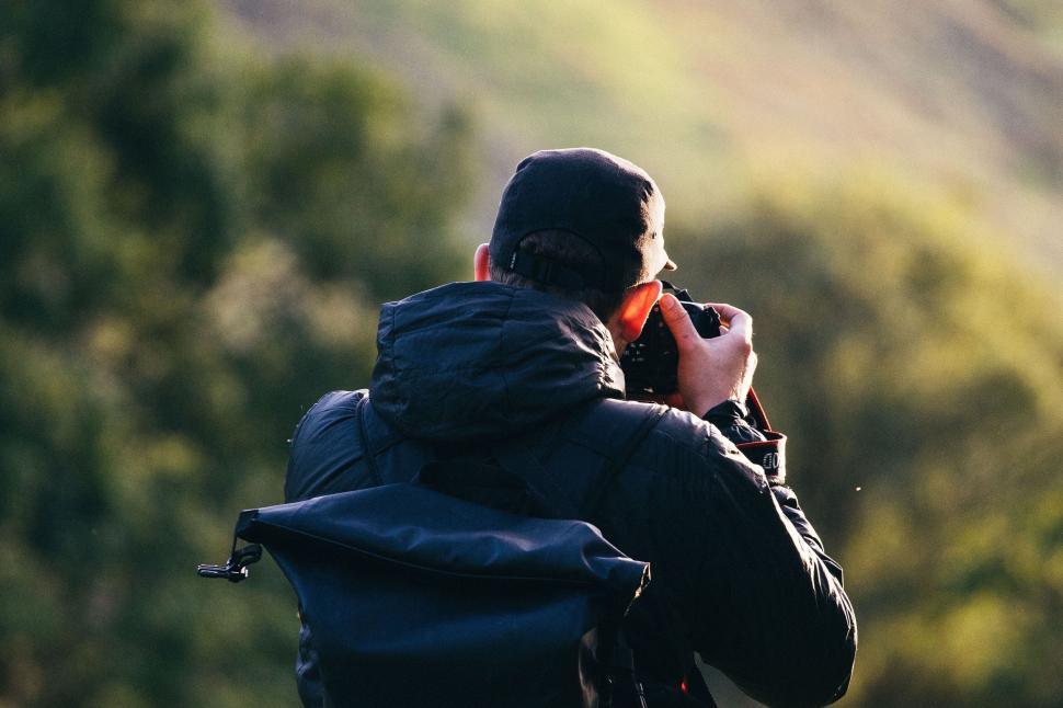 Free Image of Nature photographer capturing scenes with a camera in the wild 