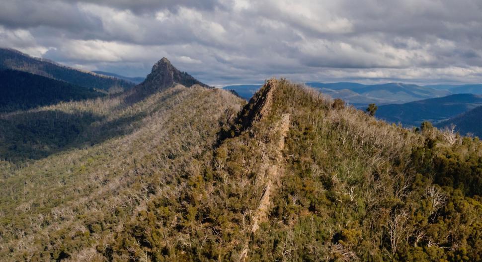 Free Image of Mountain ridges extending into the distance under a cloudy sky. 