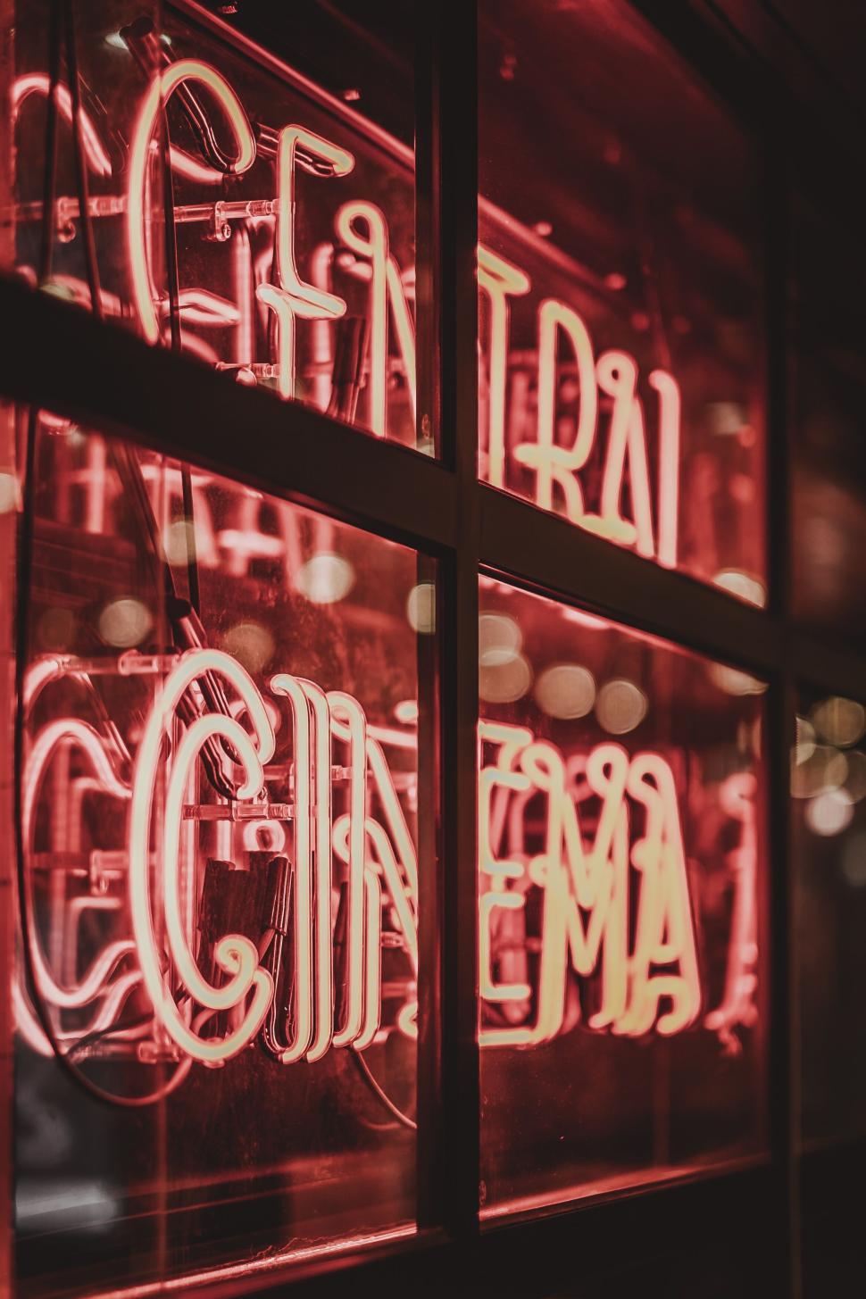 Free Image of Neon sign for cinema glowing brightly at nighttime. 