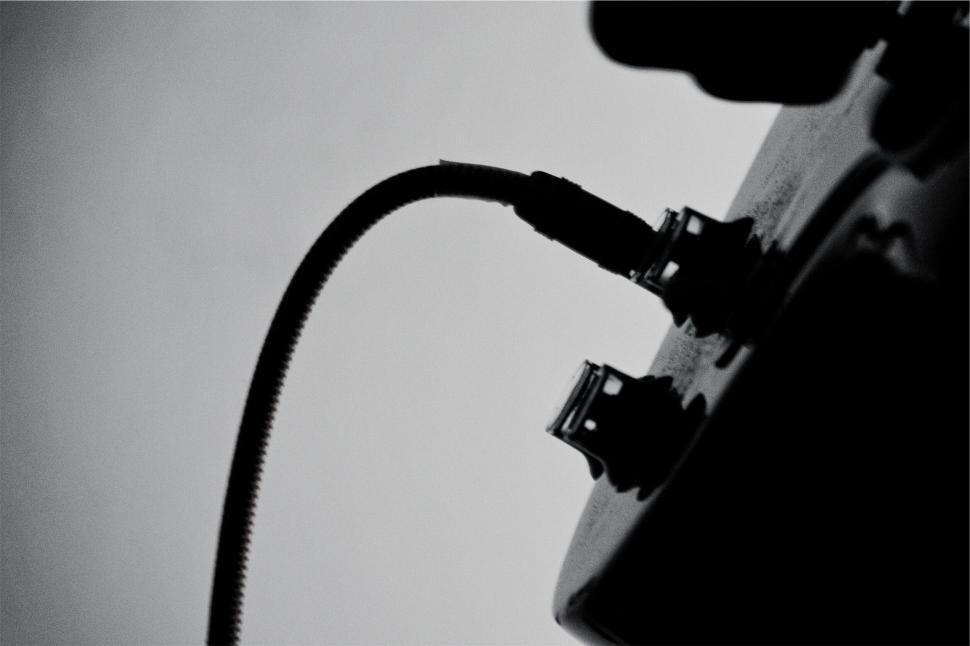 Free Image of Abstract close-up of an electric guitar input jack in black and white 