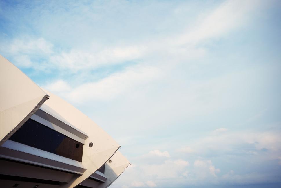 Free Image of Modern white building against a clear blue sky during daytime view 