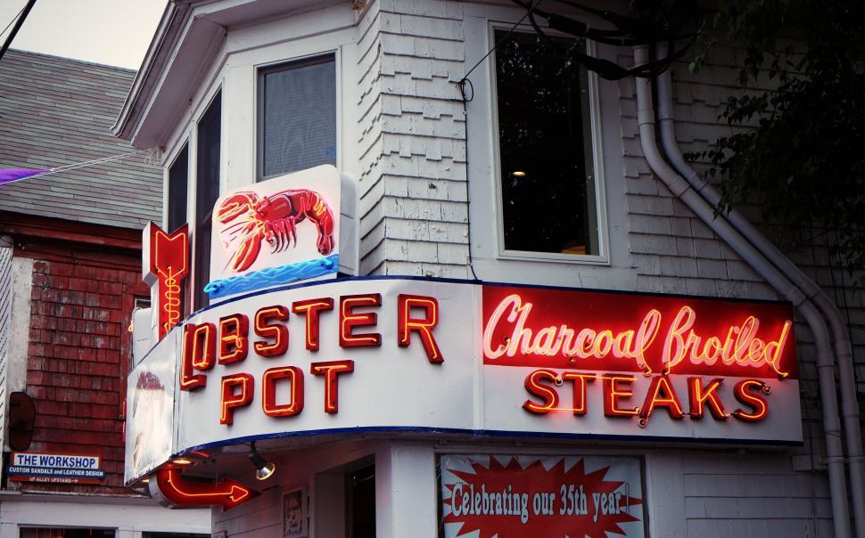 Free Image of Lobster Pot restaurant sign with vibrant neon lights in urban setting 