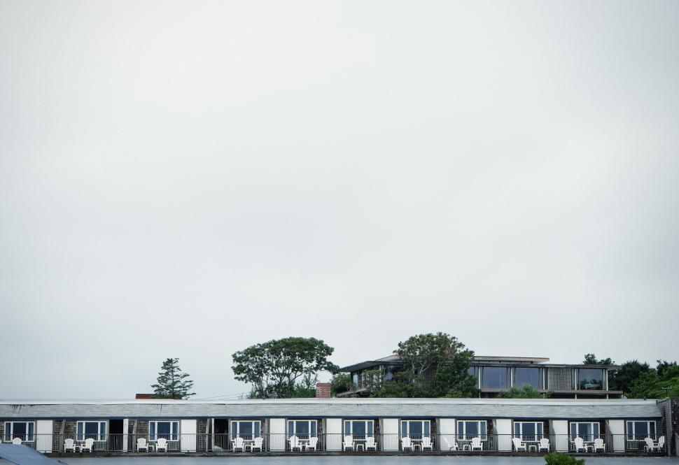 Free Image of Modern building exterior with trees and minimalistic design elements 