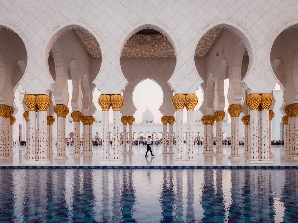 Free Image of Elegant architecture with arches and columns surrounding a pool 