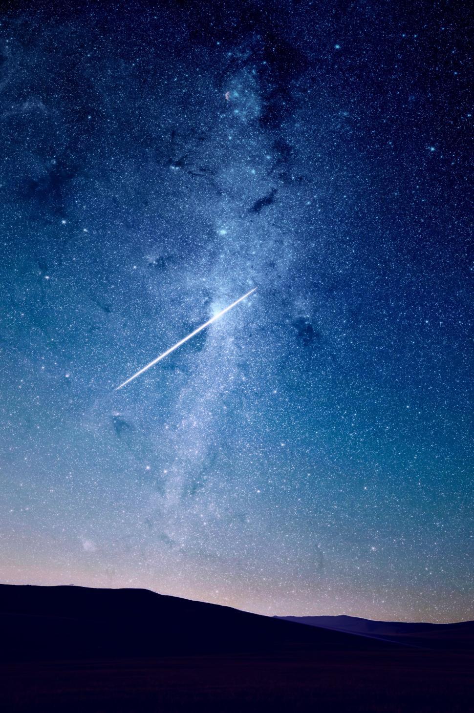 Free Image of Night sky with a meteor and countless stars illuminating the scene 