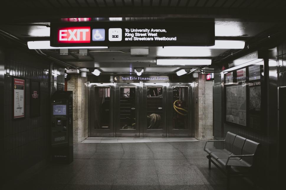 Free Image of Underground subway exit signs with dark modern interior design 