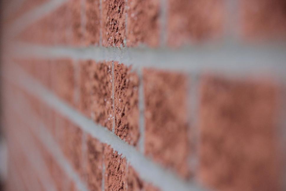 Free Image of Close-up of red brick wall showing detailed texture and cracks. 
