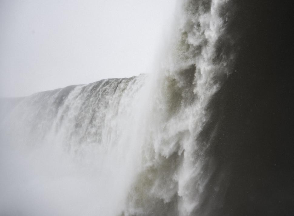 Free Image of Powerful waterfall cascading down from a great height into mist 