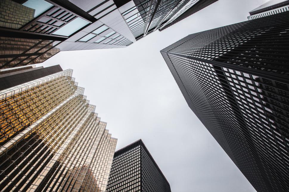 Free Image of Skyscrapers viewed from below against a cloudy sky in urban city. 