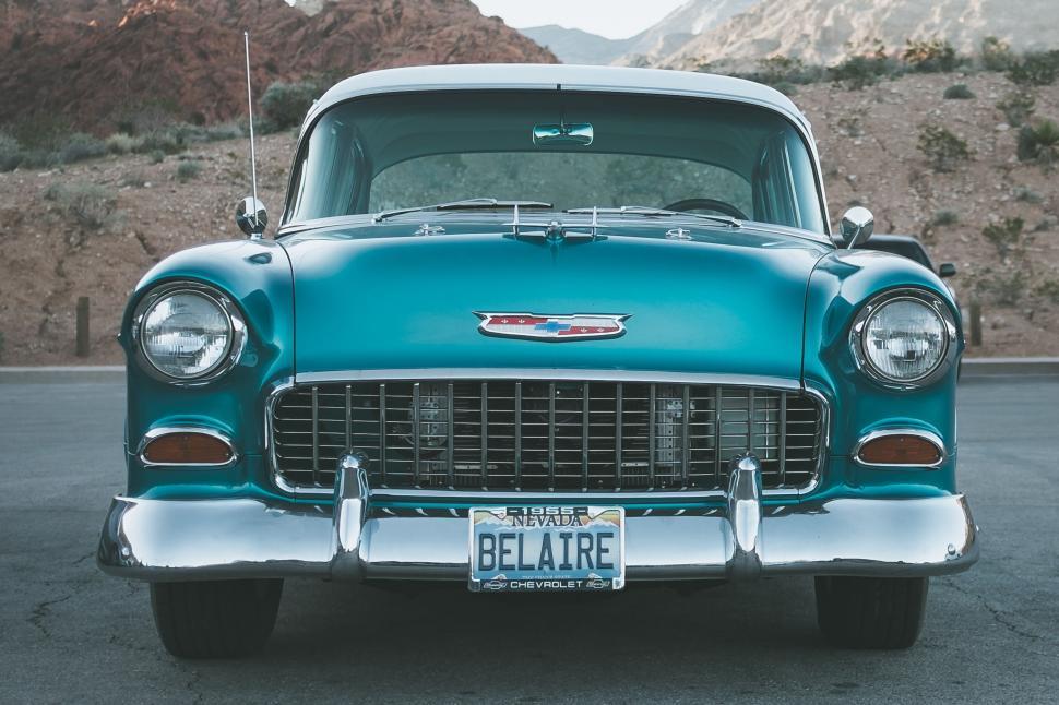 Free Image of Vintage Bel Air car in teal color parked in rocky desert area 
