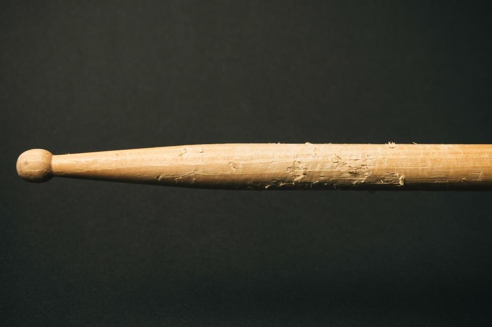 Free Image of Close-up of a worn drumstick with visible wear and tear marks 