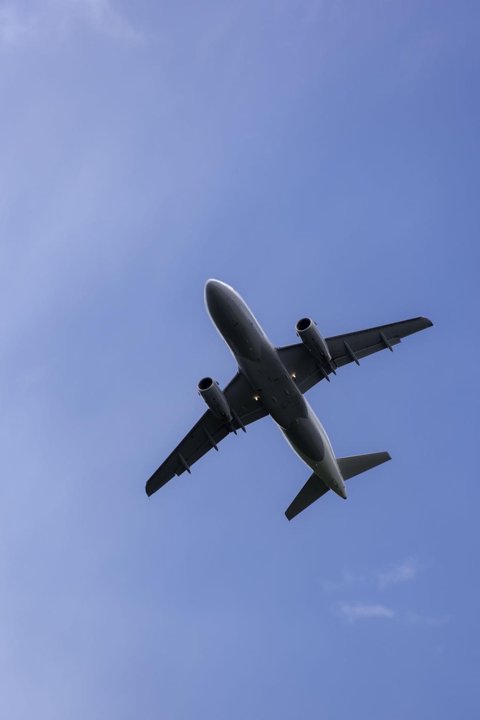 Free Image of Passenger airplane in bright blue sky during day flight close-up view 