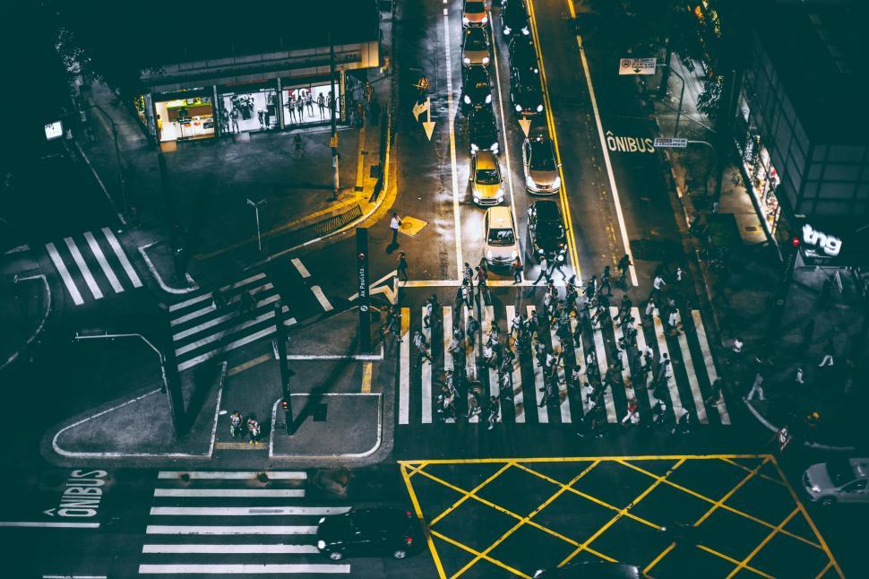Free Image of Aerial view of a busy pedestrian crossing at night in a city. 