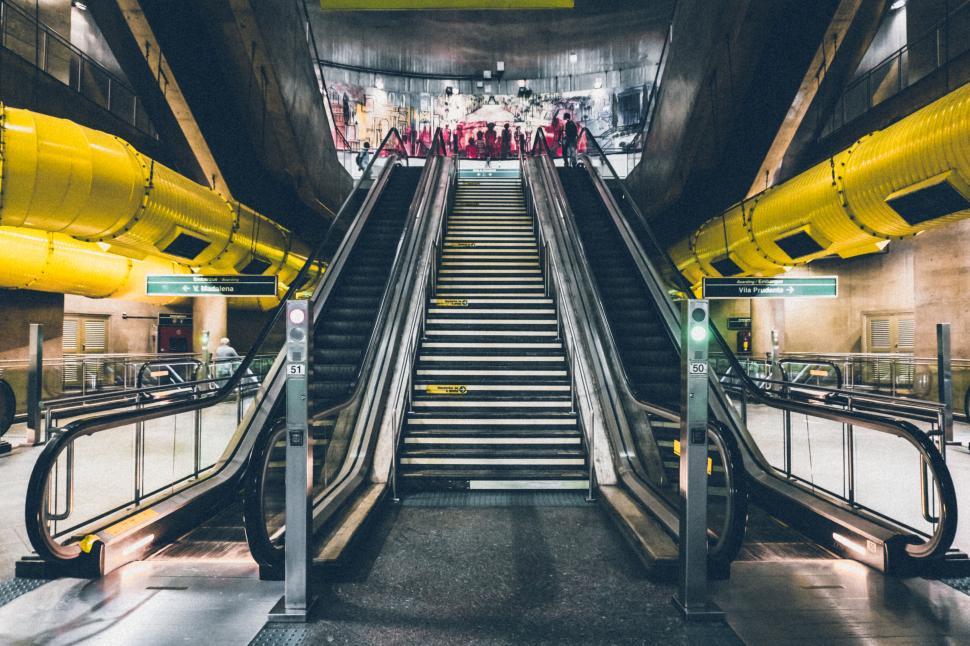 Free Image of Modern escalators and stairway in a brightly lit subway station 