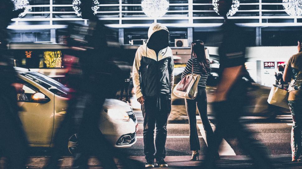 Free Image of Person in Hoodie Amidst Blurred Crowd on Bustling City Street 