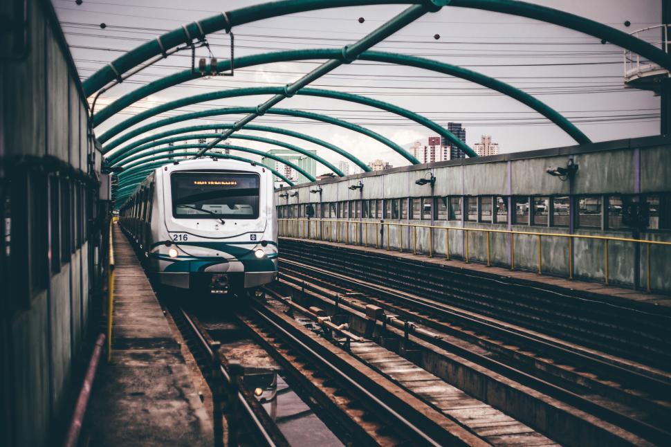 Free Image of Modern commuter train arriving at urban station under metal canopy. 