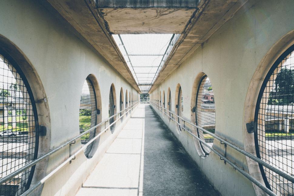 Free Image of Symmetrical architectural pedestrian bridge with circular windows 