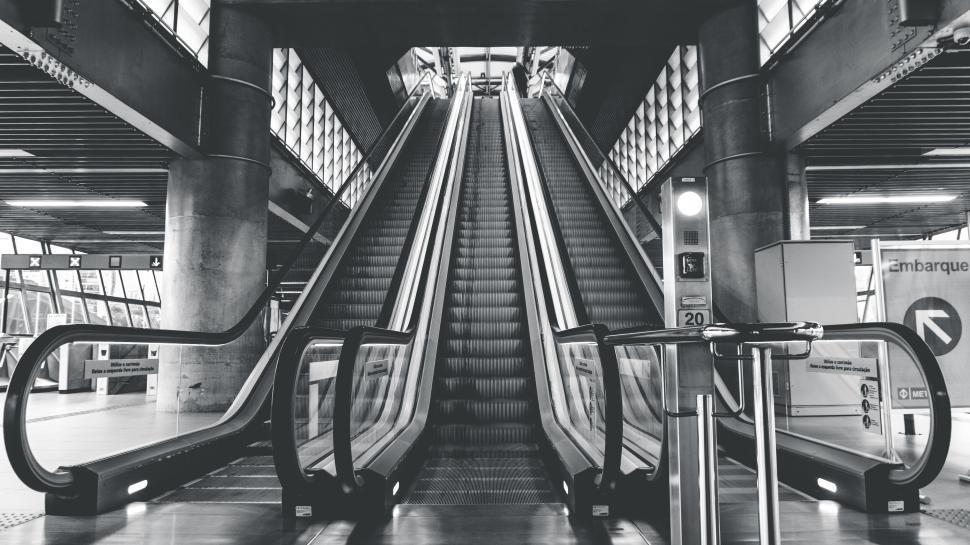 Free Image of Modern escalator in an urban station, black and white tones. 