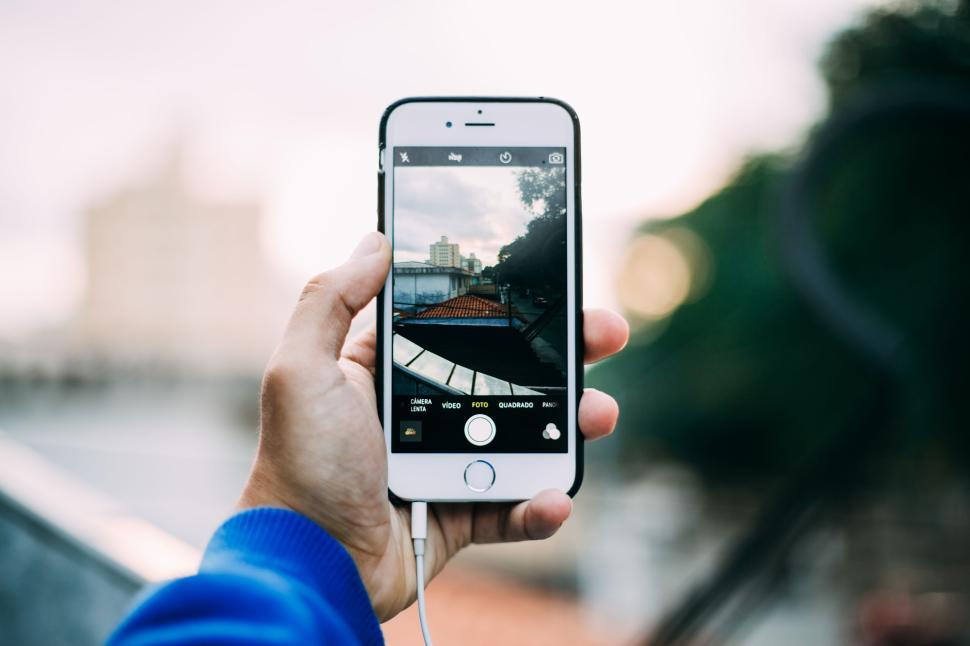 Free Image of Hand capturing cityscape with smartphone camera in candid pose. 