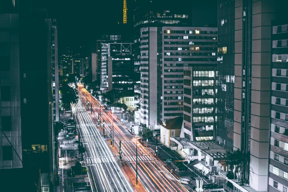 Free Image of Vibrant night cityscape with light trails from passing cars. 