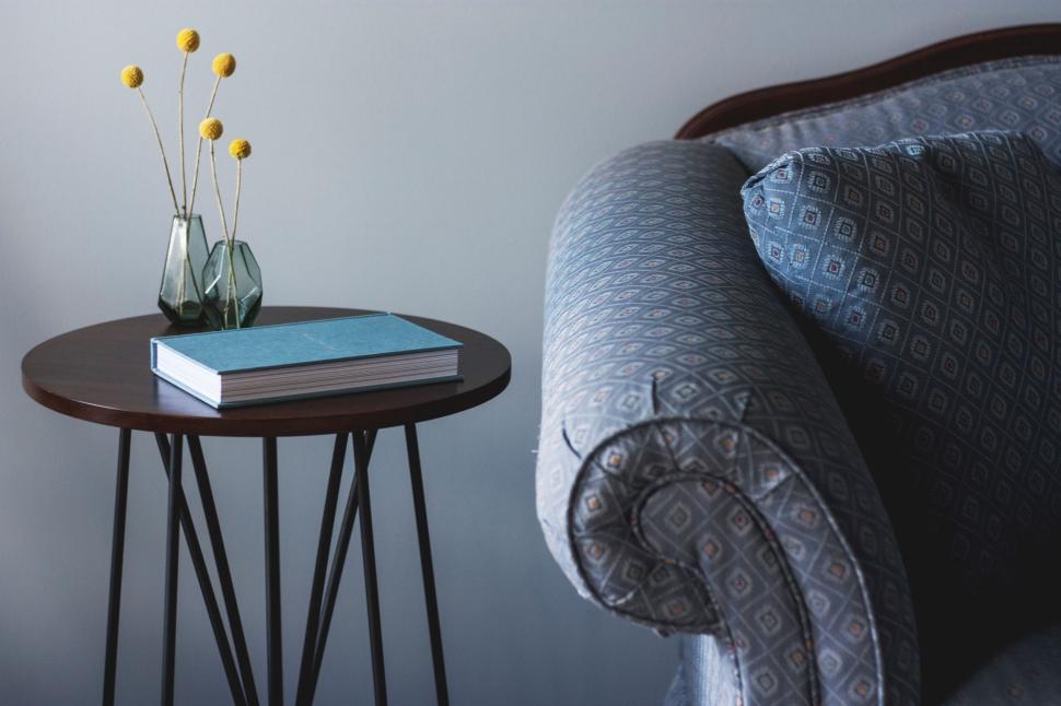 Free Image of Cozy living room corner with a sofa, table, and decorative items. 