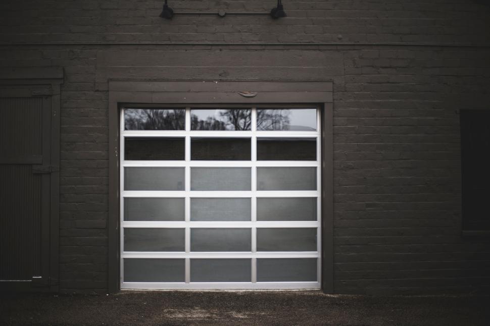 Free Image of Modern garage door on a dark-bricked exterior in natural light. 