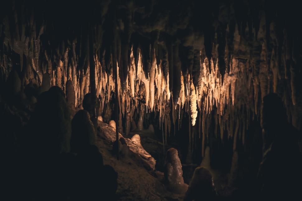Free Image of A mesmerizing view of stalactites and stalagmites inside a cave 