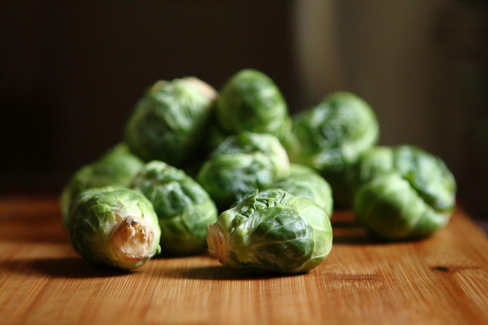 Free Image of Fresh green Brussels sprouts on a wooden surface in kitchen 