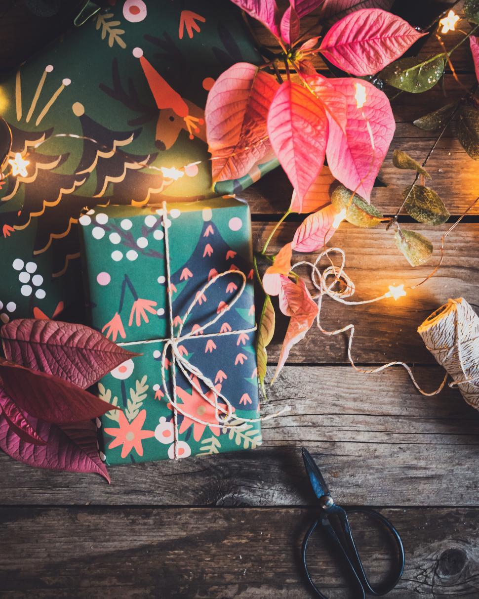 Free Image of Beautifully wrapped presents with festive decorations and lights 