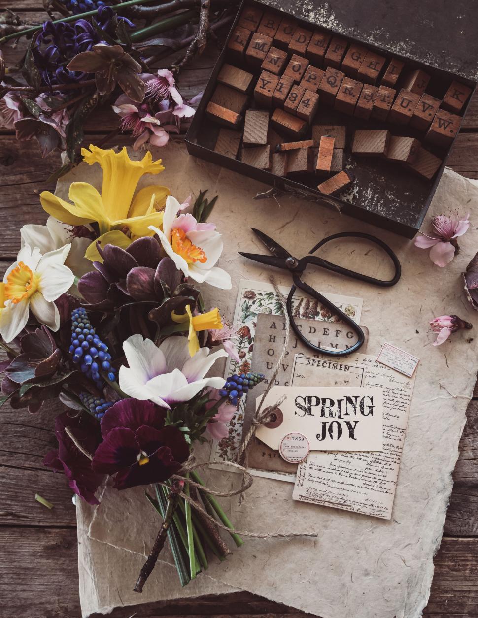 Free Image of Spring flowers and crafting materials on rustic wooden table 