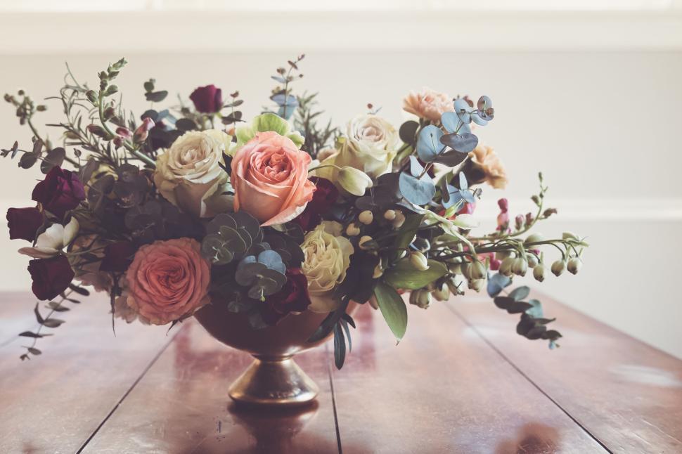 Free Image of Elegant bouquet of mixed flowers on a wooden table in a bowl. 