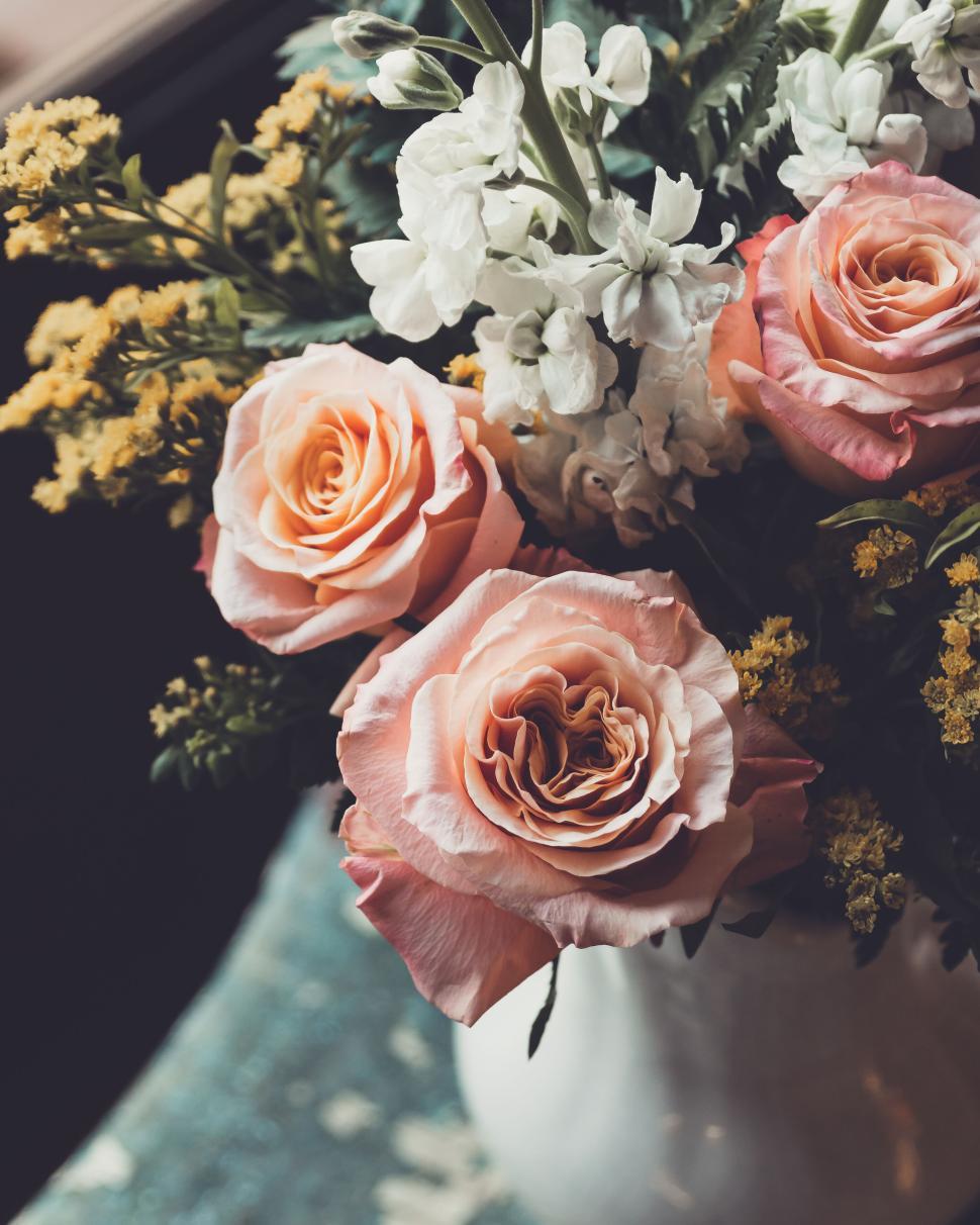Free Image of Elegant peach and white flowers in a vase with blurred background 
