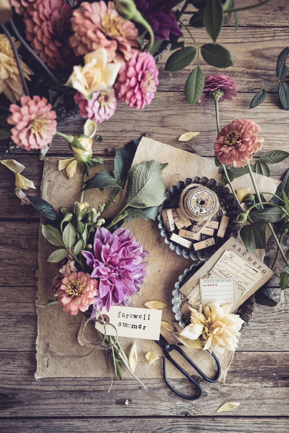 Free Image of Artistic flat lay composition with flowers, papers, and scissors 