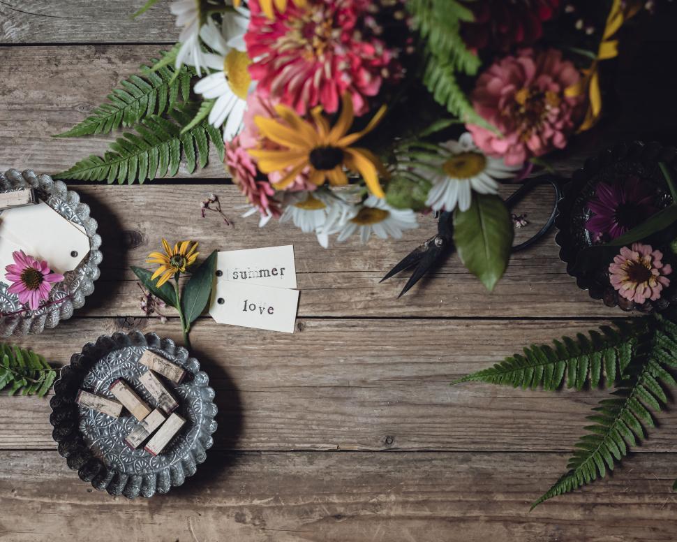 Free Image of Top view of vintage flowers and notecard on a wooden table setting 