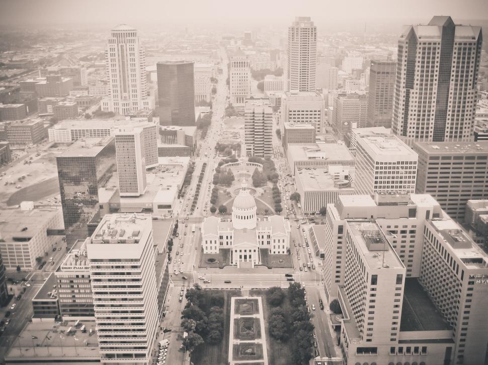 Free Image of Aerial view of a cityscape with a prominent historic courthouse. 