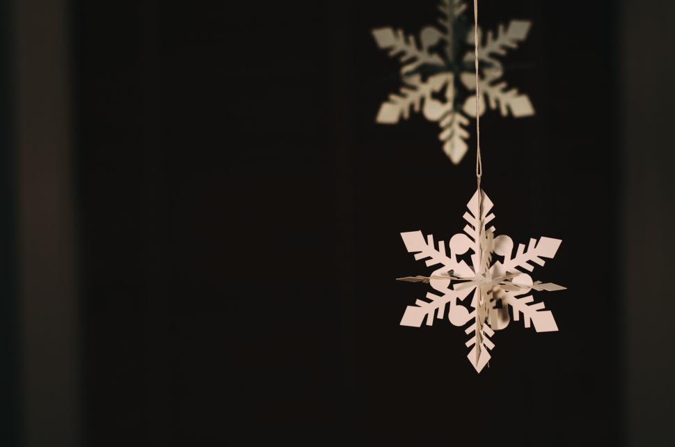 Free Image of Hanging white paper snowflake decoration photographed in focus. 