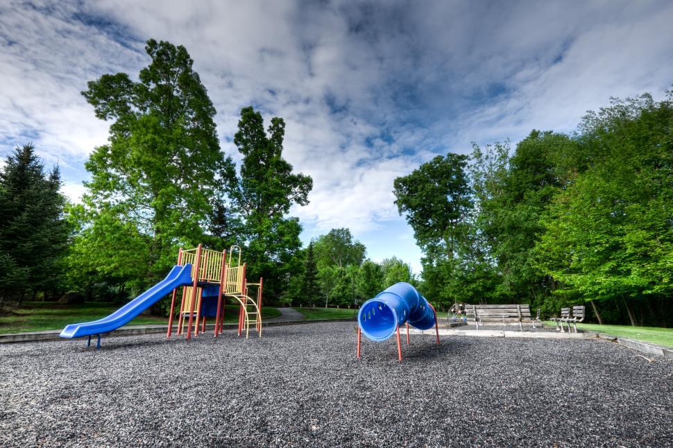 Free Image of Colorful children’s playground with blue tunnel slides on sunny day 
