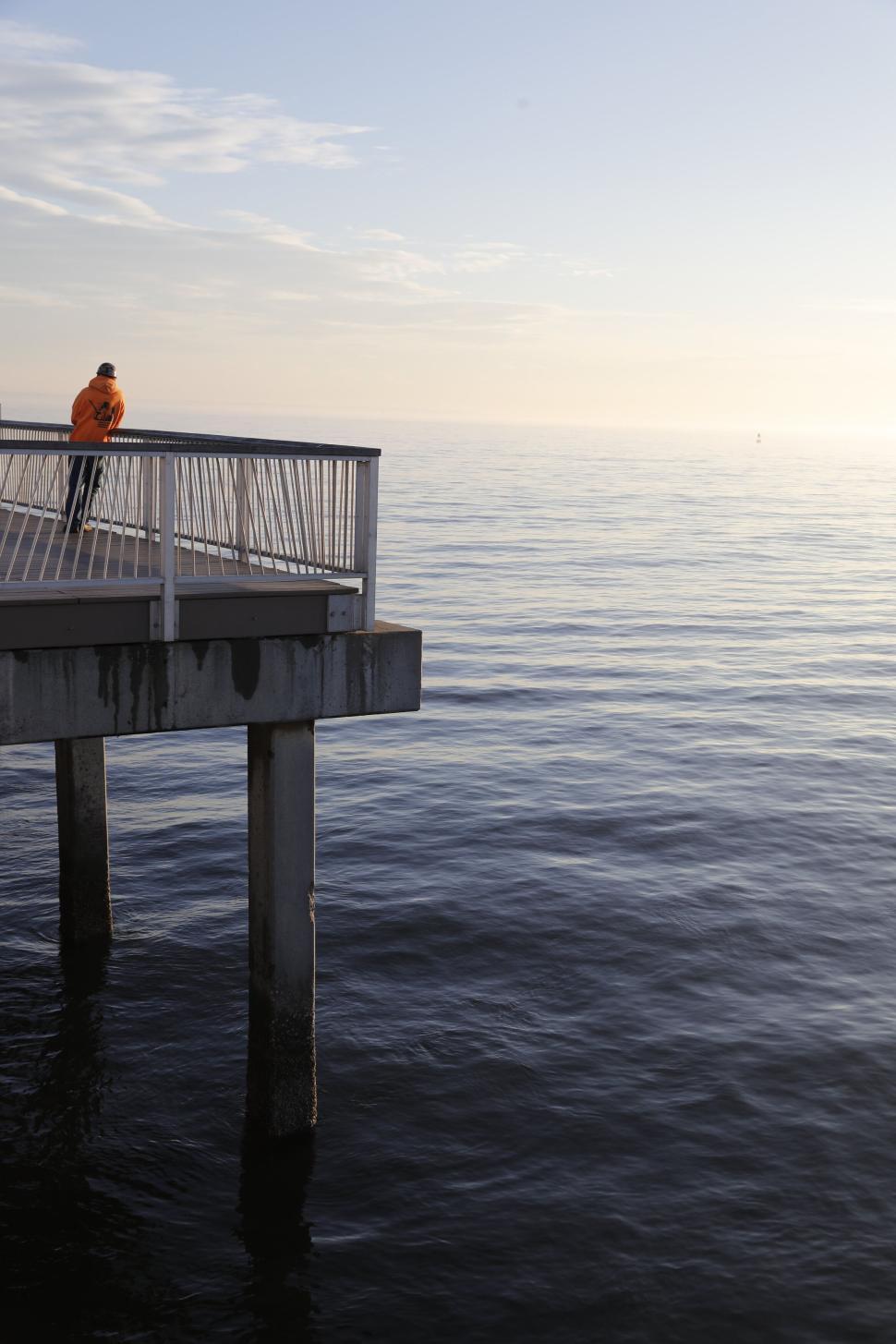 Free Image of Peaceful pier overlooking the calm ocean under a pastel sky. 