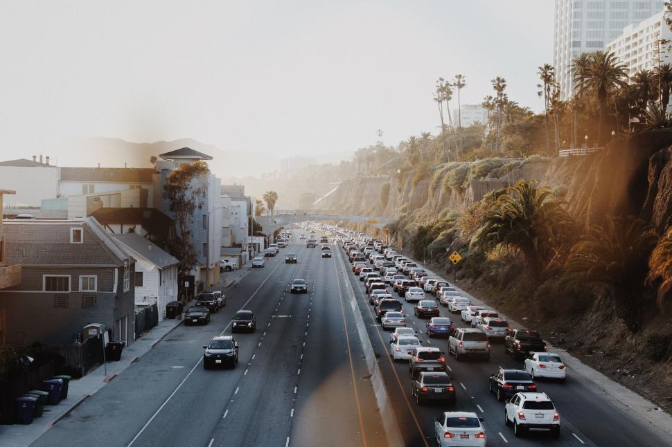 Free Image of Busy urban highway near the coastline filled with cars at sunset 