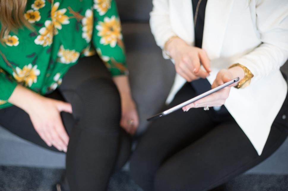 Free Image of Two people meeting and discussing something over a tablet. 