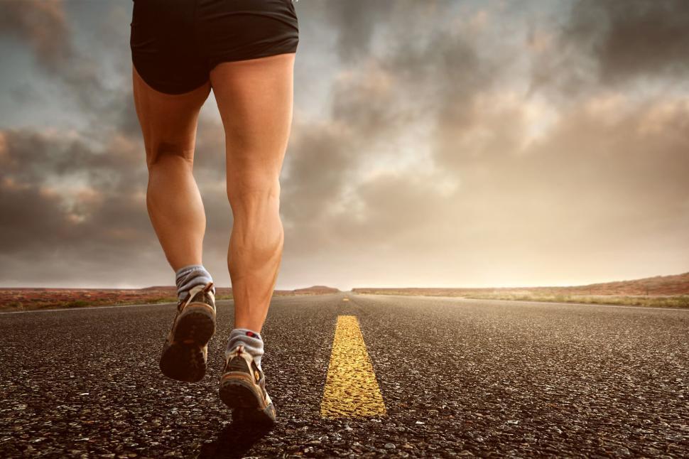 Free Image of Runner s legs on an open road during a beautiful sunset jog 