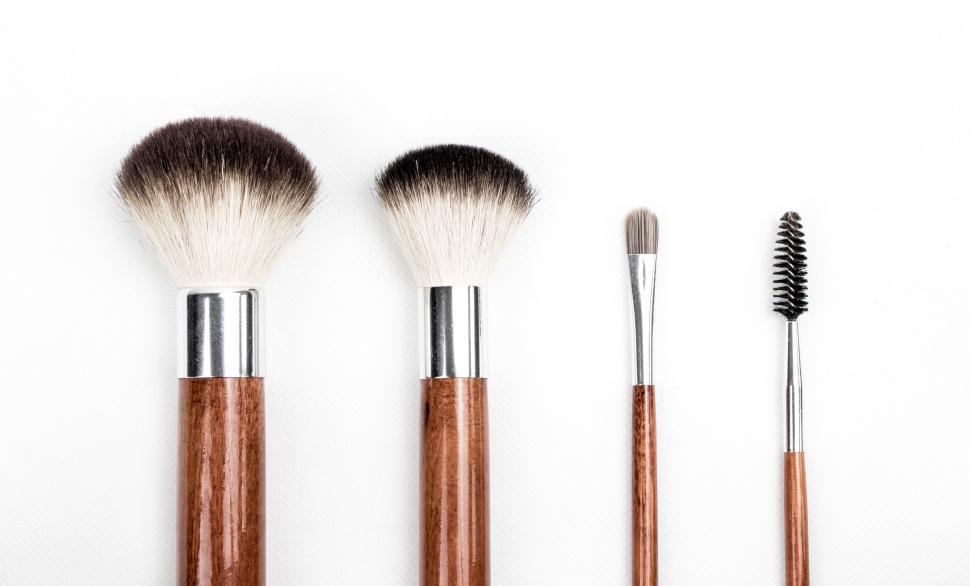 Free Image of Four different makeup brushes of various sizes on white background. 