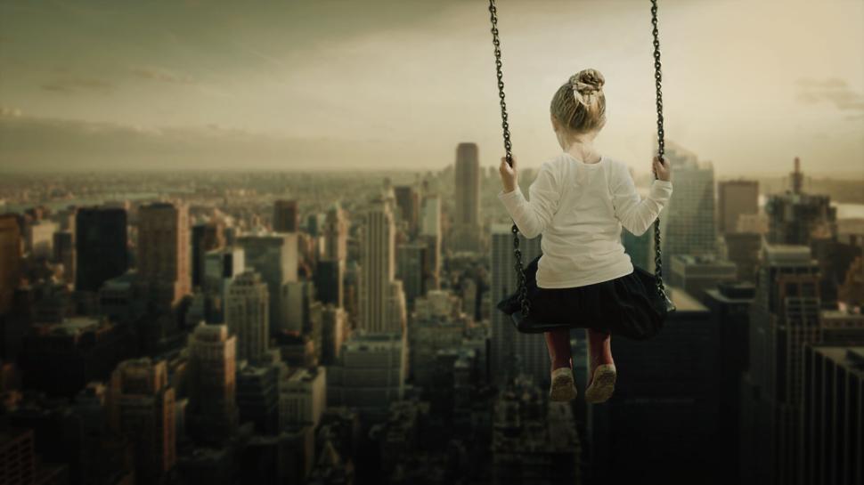 Free Image of Girl on a swing high above a city skyline at twilight, dreaming big. 