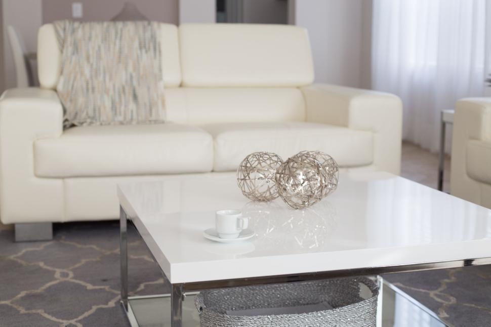 Free Image of Modern living room with white leather couch and coffee table. 