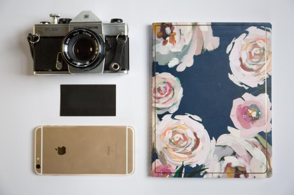 Free Image of Vintage camera, notebook, and smartphone arranged on table 