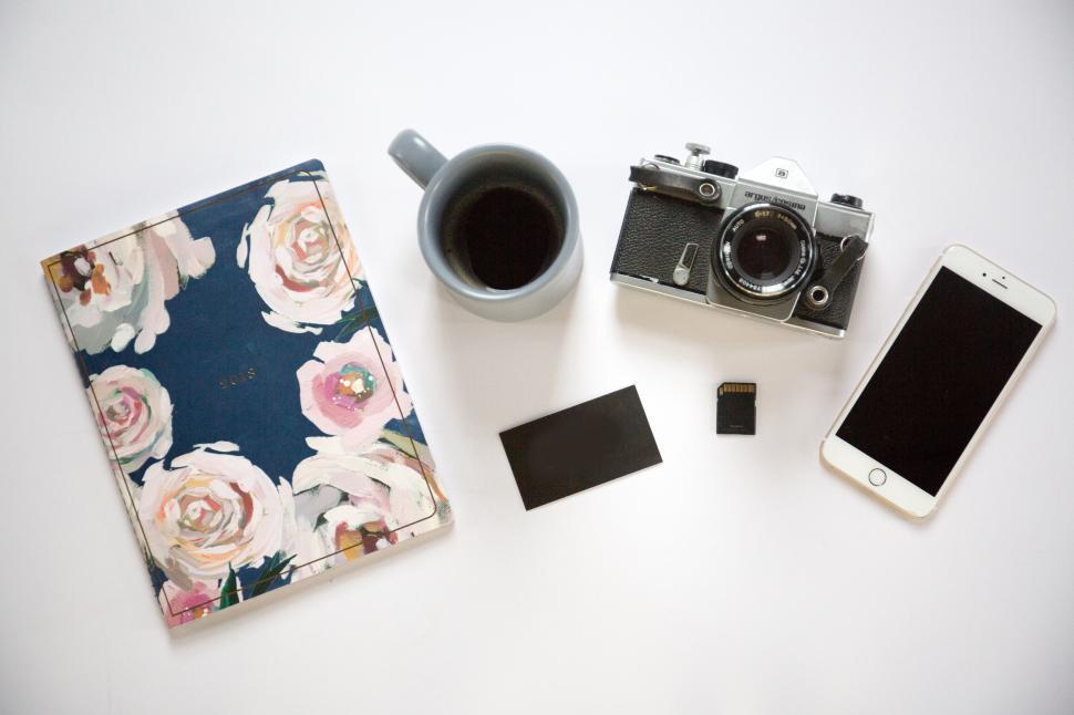 Free Image of Vintage camera and coffee with floral notebook and iPhone layout 