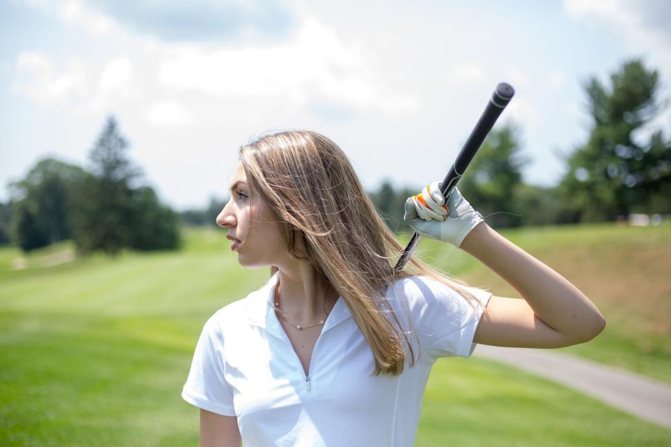 Free Image of Golf player holding club on the field ready to swing 