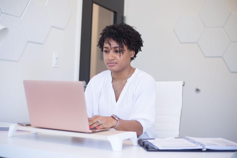 Free Image of Focused woman working on a laptop in a modern office 
